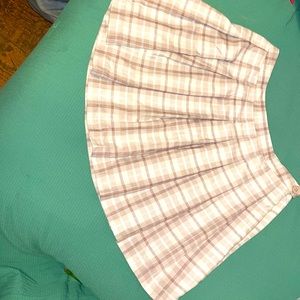 Brown, white and beige plaid skirt. Zip up on side with additional button